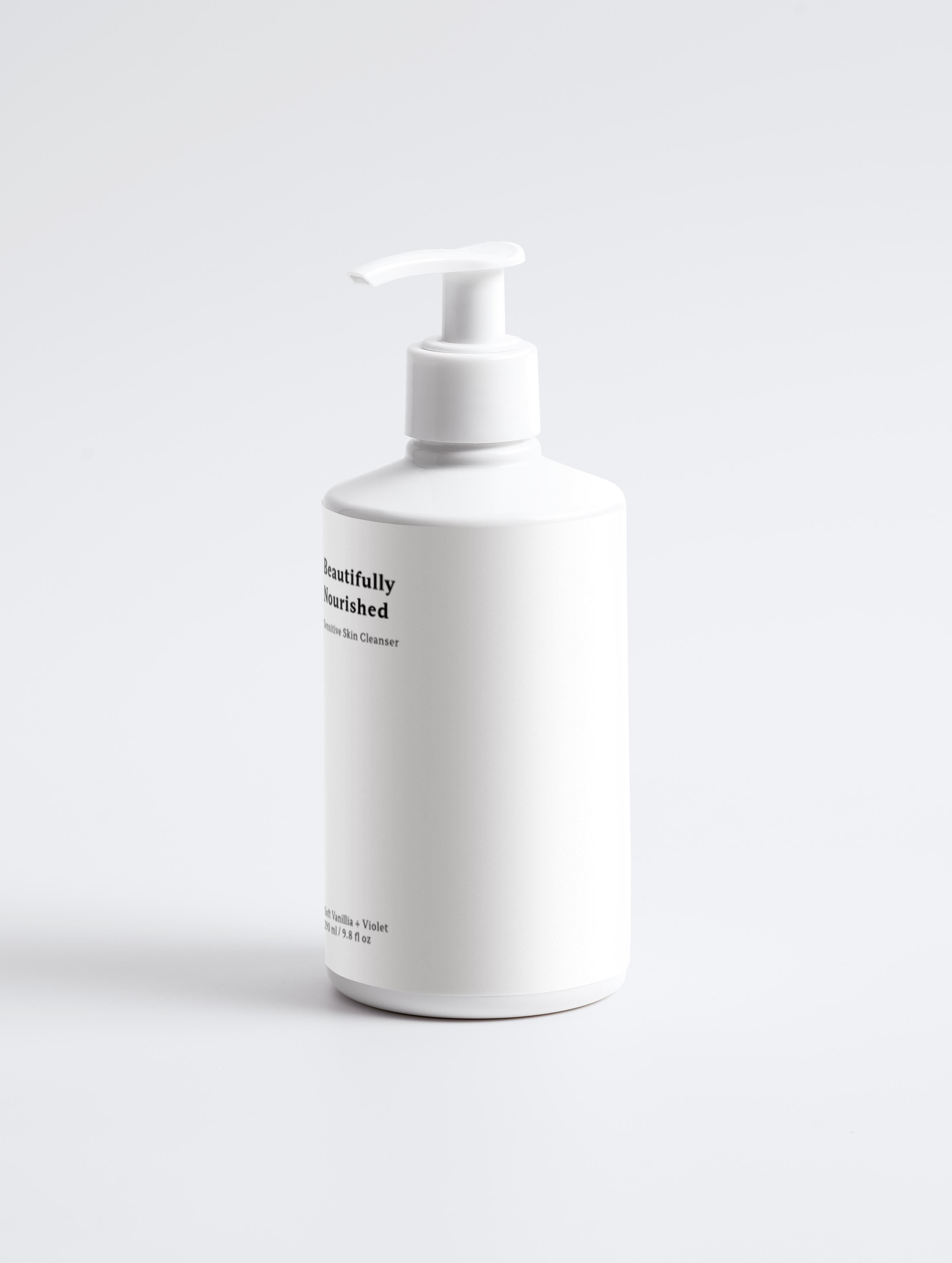 A pump bottle of beautifully nourished Violet and Vanilla Sensitive Skin Face & Body Cleanser against a white background.