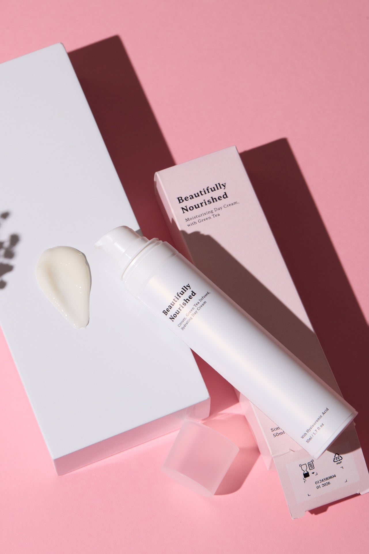 Beautifully Nourished day cream with green tea skincare product with packaging on a pink background