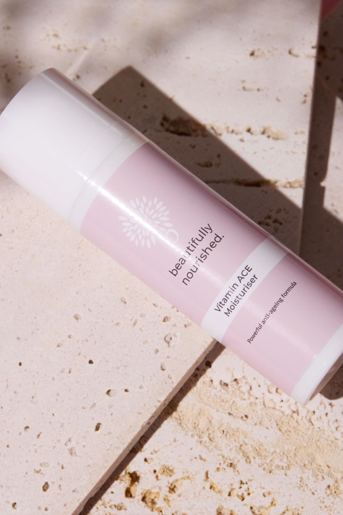 Beautifully nourished antioxidant face cream with vitamins a, c and e, on a textured surface.