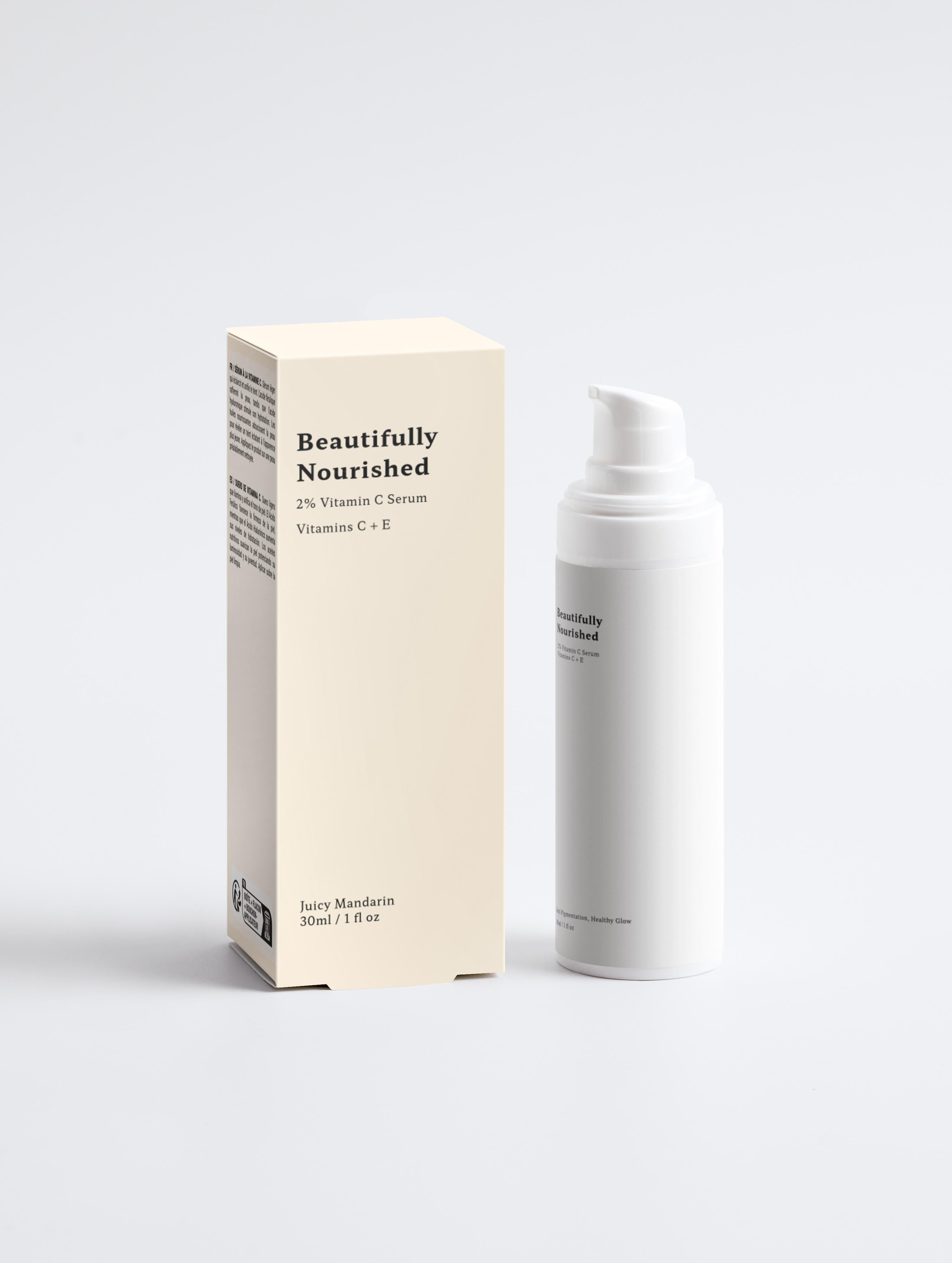 A pump bottle of '2% Vitamin C Serum' next to its packaging box, both with brand 'Beautifully Nourished' visible.