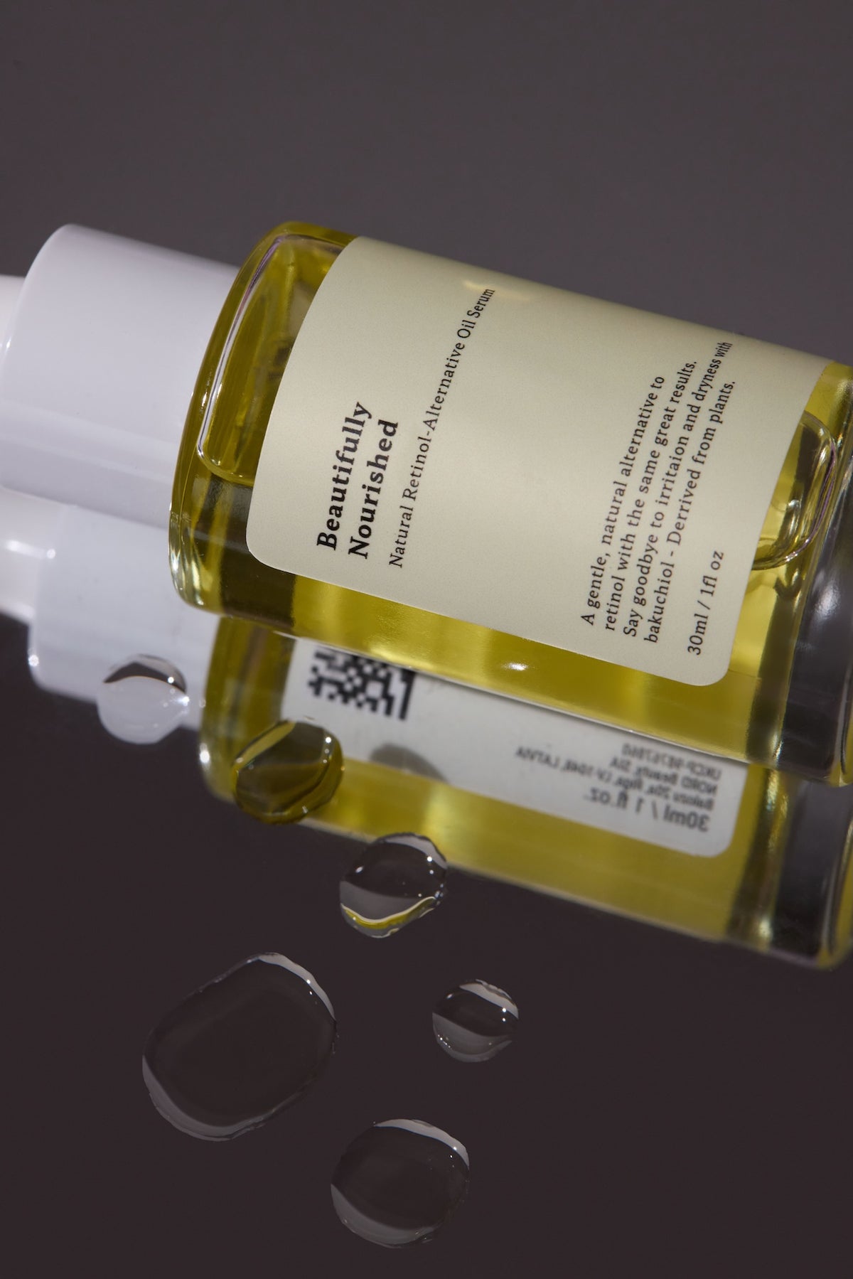 Bottle of Beautifully Nourished natural skincare on a reflective surface with a dark background