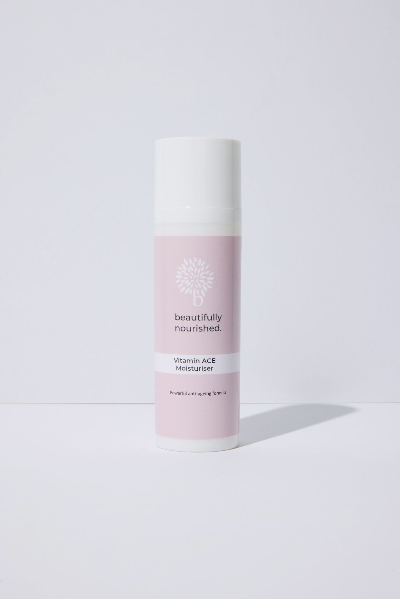 Skincare bottle labeled 'beautifully nourished' on a white background featuring moisturiser to protect and rejuvenate the skin